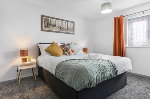 a bedroom with a large bed with a night stand at Villa Casa in Birmingham