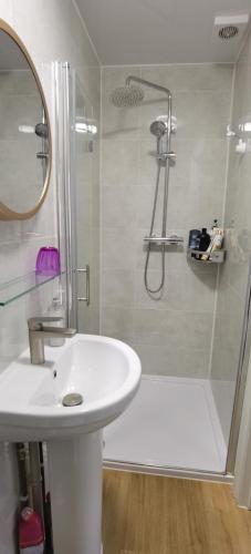 a bathroom with a white sink and a shower at Comfy 2 bedroom Apt in central location, Newly Refurbished in Plymouth