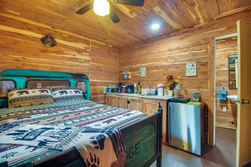 a log cabin bedroom with a bed and a sink at Fish, Hike and More Ozark Cabin on 300 Acres in Ozark