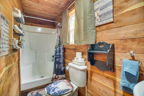 a small bathroom with a toilet and a sink at Fish, Hike and More Ozark Cabin on 300 Acres in Ozark