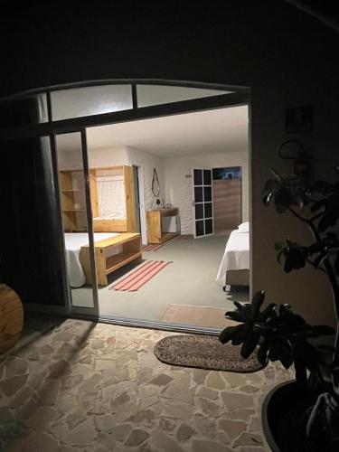 a room with a bedroom with a bed and a mirror at Pousada Vila Flow in Cumbuco