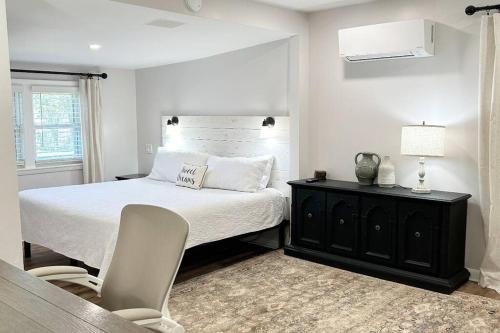 a bedroom with a bed and a table and a chair at Norris Lake Modern Farmhouse Retreat in Sharps Chapel