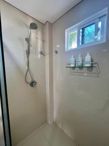 a bathroom with a shower and a window at Pousada Vila Flow in Cumbuco