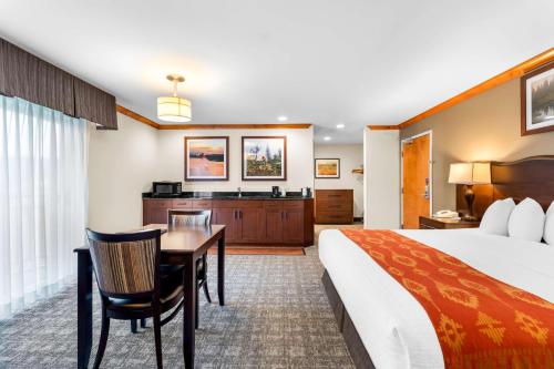a hotel room with a bed and a desk at Best Western Rocky Mountain Lodge in Whitefish