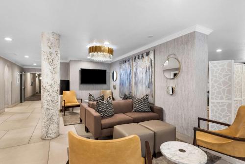 a living room with a couch and a tv at Best Western Plus Abbey Inn in St. George