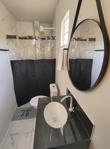 a bathroom with a sink and a mirror at Pousada dos Ventos in Paranatama