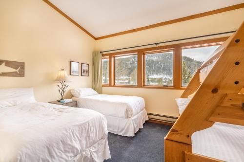 a bedroom with two beds and a staircase at Tennis Townhome 1337 : 2 in Keystone