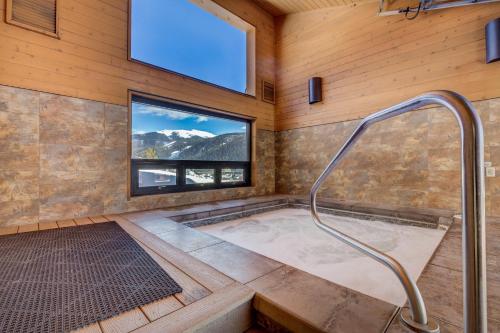 a jacuzzi tub in a room with a window at Tennis Townhome 1337 : 2 in Keystone