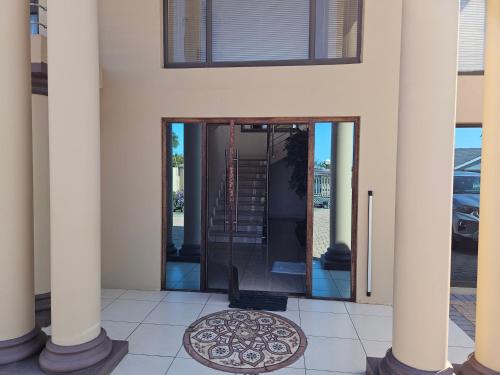a front door of a house with columns at Mix Guesthouse in Gqeberha