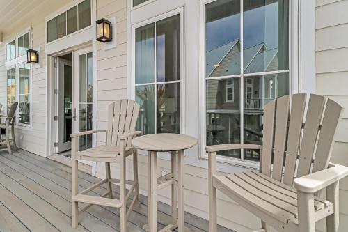 two chairs and a table on a porch at Fridays Comin 132 BAR in Mustang Beach