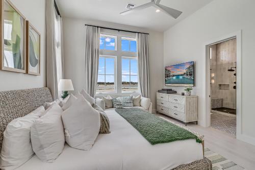 a white bedroom with a large bed and a window at Fridays Comin 132 BAR in Mustang Beach