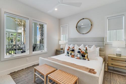 a bedroom with a bed with a mirror and windows at Fridays Comin 132 BAR in Mustang Beach