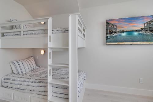 a bunk bed in a room with a bed and a picture at Fridays Comin 132 BAR in Mustang Beach