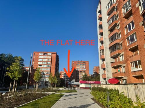 a street in a city with a sign that reads the flat here at Holiday Ap in Visaginas