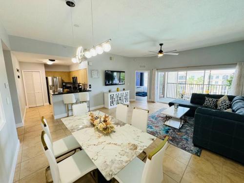 a dining room and living room with a table and chairs at Luxurious & Epic Condo in heart of Orlando in Orlando
