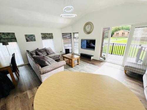 a living room with a couch and a table at 3 Bedroom Lodge SG2, Lower Hyde, Isle of Wight in Shanklin