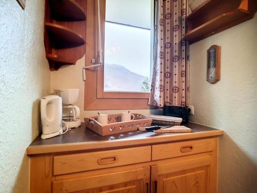 un comptoir de cuisine avec un évier et une fenêtre dans l'établissement Résidence Boedette A - Appartement confortable · Départ et retour skis aux pieds · Balcon MAE-1004, aux Menuires