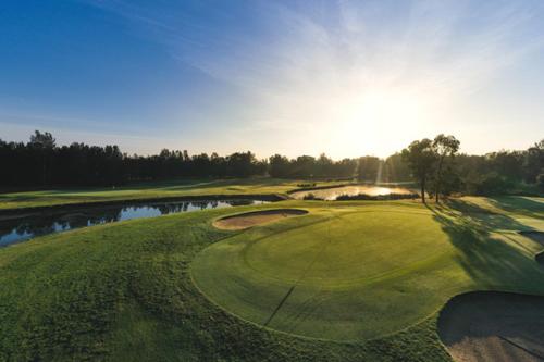 an aerial view of a golf course with a pond at Blue Haven Retreat - Glenmore Park Pool Home in Glenmore Park