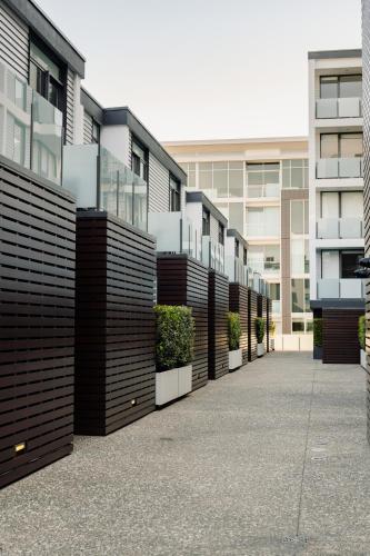 a row of apartment buildings with plants on them at Pavilions Marina Apartment 104 - Wynyard Quarter Viaduct Harbour in Auckland