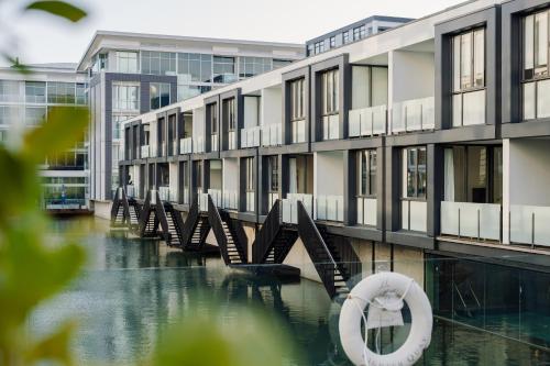 a row of buildings with a raft in the water at Pavilions Marina Apartment 104 - Wynyard Quarter Viaduct Harbour in Auckland