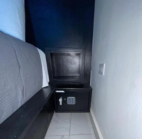 a corner of a room with a bed next to a wall at LEVEL suites #8 in Sosúa