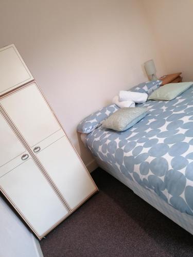 a bedroom with a bed with two drawers and a mirror at Hygis Home Of Relaxations in Stoke on Trent