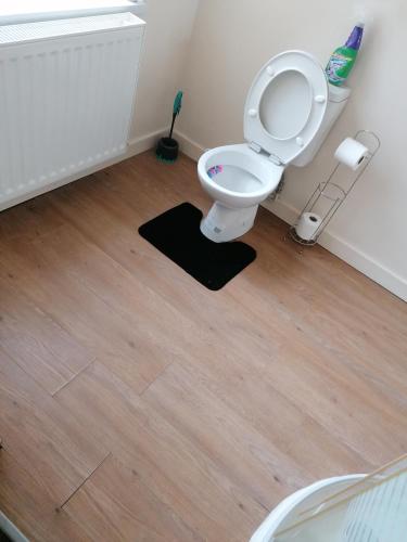 a bathroom with a toilet with the seat up at Hygis Home Of Relaxations in Stoke on Trent