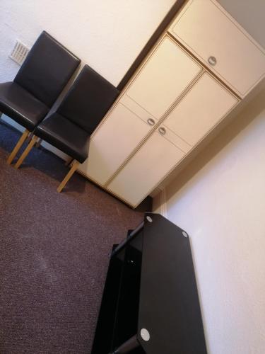 an office with two chairs and a desk at Hygis Home Of Relaxations in Stoke on Trent