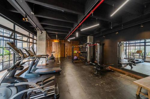 a gym with several tread machines in a room at Morph Candelaria - Gestion Hotelera in Bogotá
