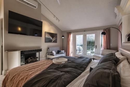a living room with a large bed and a tv at Skyline Villa Indoor Pool Hot Tub in Millard