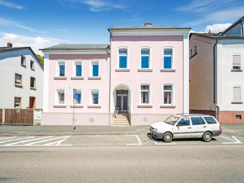 a car parked in front of a pink building at Apartment in Bad Camberg near Taunus Mountains in Bad Camberg