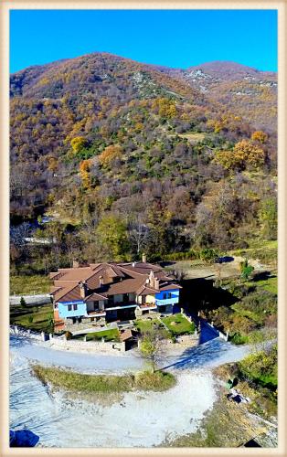 a house on a hill next to a river at Voreas Hotel in Kato Loutraki