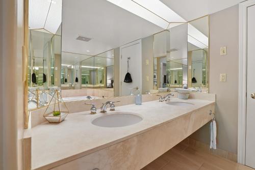 ein großes Badezimmer mit zwei Waschbecken und Spiegeln in der Unterkunft King Bed, Balcony, Pool, Hot Tub, Sauna in Edgar