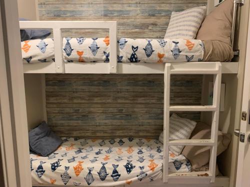 a bunk bed with pillows on the bottom bunk at Corpus Christi North Beach Cozy Condo, 2 Heated pools and Balcony Ocean Views! in Corpus Christi
