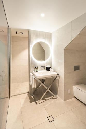 a bathroom with a sink and a shower at Queenstown Park Boutique Hotel in Queenstown