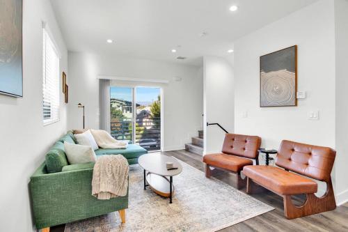 a living room with a couch and a chair at Fresh & New Downtown LA Condo! in Los Angeles