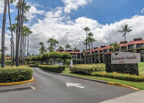 a road leading to a resort with palm trees at Rear Ocean View 2 Bedroom Single Level Condo at Kamaole Sands 9-305 in Wailea