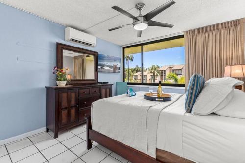 a bedroom with a bed with a ceiling fan at Rear Ocean View 2 Bedroom Single Level Condo at Kamaole Sands 9-305 in Wailea