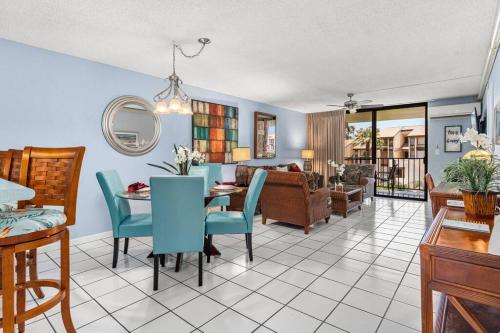 a dining room and living room with a table and chairs at Rear Ocean View 2 Bedroom Single Level Condo at Kamaole Sands 9-305 in Wailea