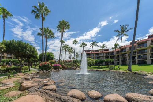 a fountain in a pool in front of a resort at Rear Ocean View 2 Bedroom Single Level Condo at Kamaole Sands 9-305 in Wailea