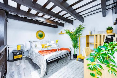 a bedroom with a bed with an orange blanket at Sun Love Old San Juan in San Juan