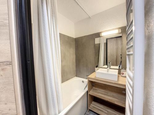 une salle de bain avec une baignoire et un lavabo et une baignoire dans l'établissement Résidence Bouquetins A - Studio coin montagne rénové pour 6 personnes MAE-8944, à Montvalezan