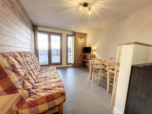 un salon avec un canapé et une table dans l'établissement Résidence Balcons De Tarentaise Bat B - 