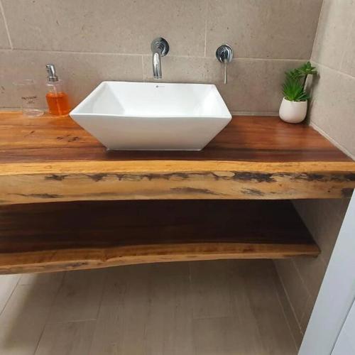 a white sink on a wooden counter in a bathroom at Casa Vacacional Almendros in El Conacaste