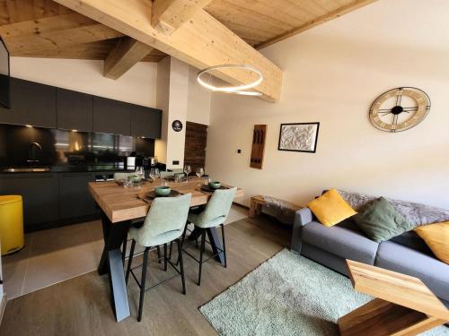 une cuisine et un salon avec une table et un canapé dans l'établissement Résidence Le Confidentiel - Bel appartement 4 personnes au centre du village MAE-2391, aux Gets