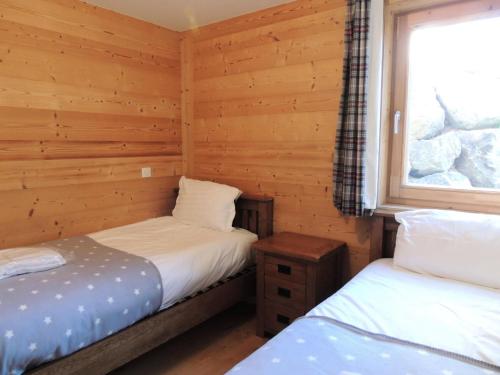- 2 lits dans une cabane en rondins avec fenêtre dans l'établissement Chalets Eden Snow - Appartement spacieux MAE-2481, aux Gets