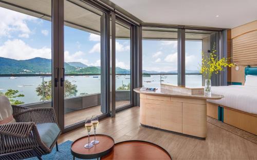 a hotel room with a bed and a view of the water at WM Hotel Hong Kong, Vignette Collection in Hong Kong