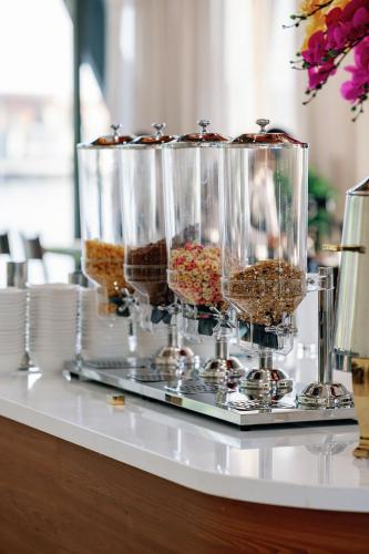 a buffet with three containers of food on a table at Lamori Resort & Spa in Thanh Hóa