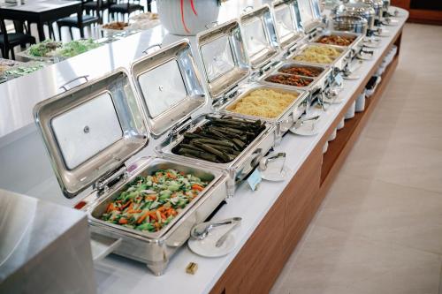 a buffet line with many trays of food at Lamori Resort & Spa in Thanh Hóa