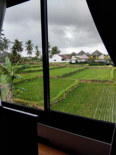 a window view of a rice field at Sujiwa Ubud Hotel & Villa in Ubud